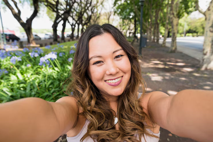 files/portrait-smiling-young-woman-taking-selfie-park_23-2148027178.avif